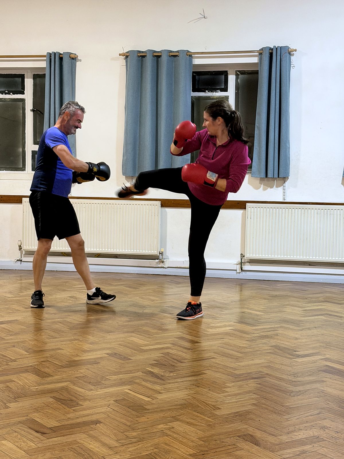 Member throwing a kick at the pads